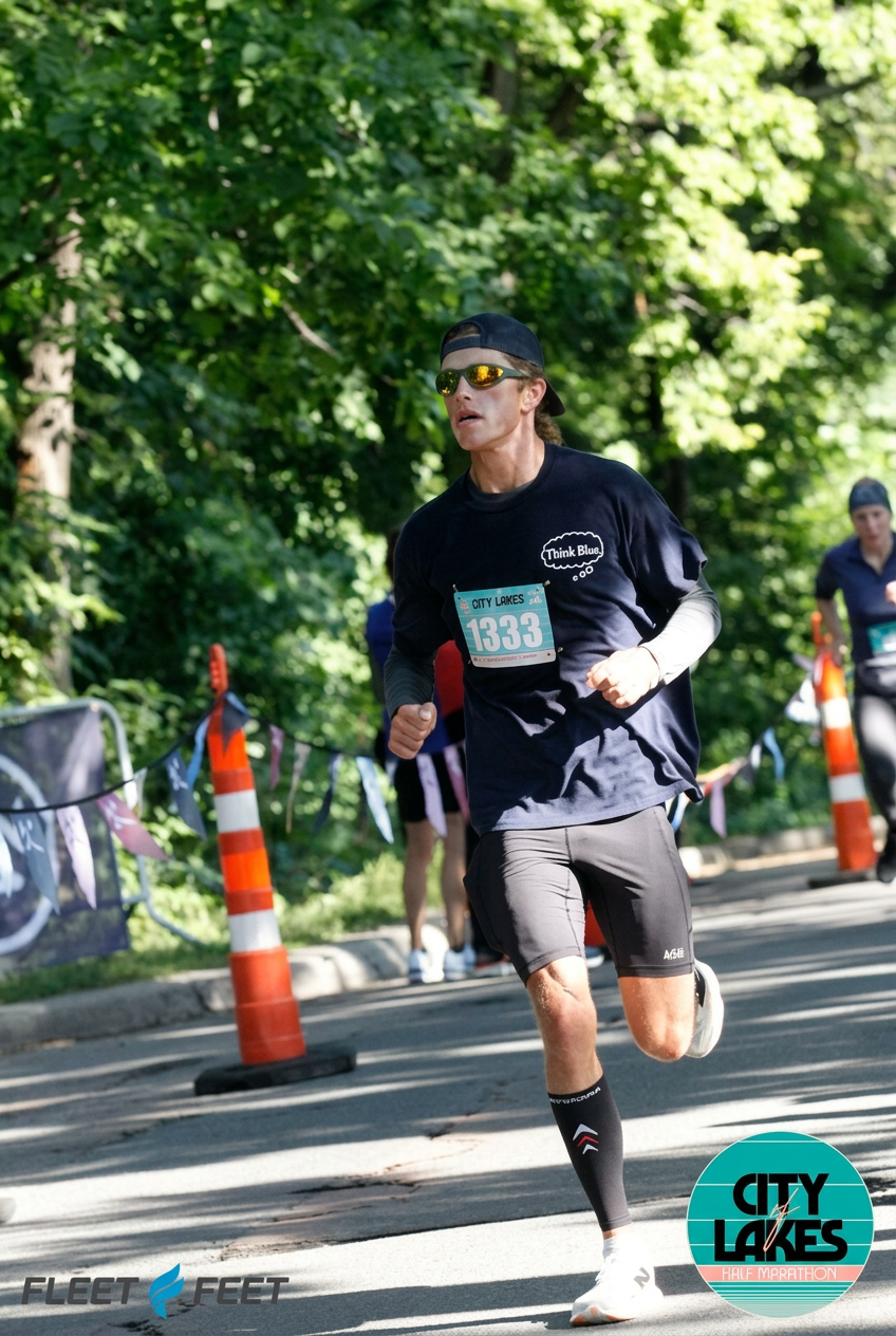 Anthony running a half marathon on a tree-lined road