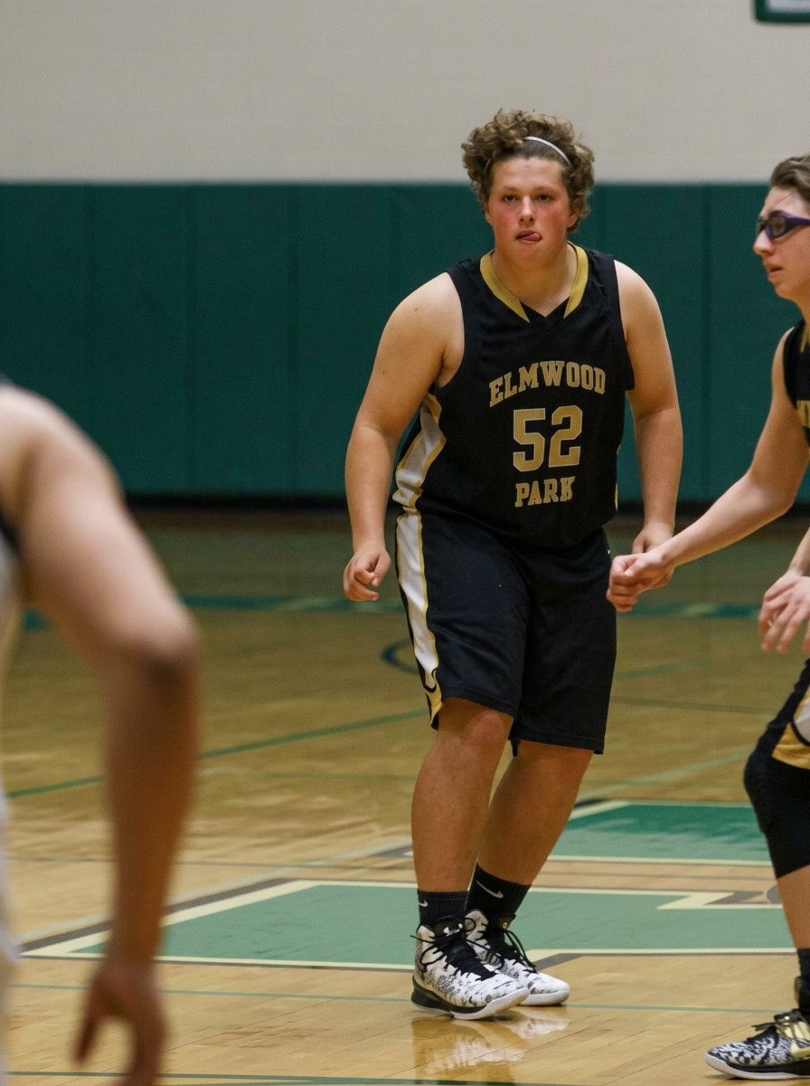 Anthony as a teen, overweight, playing basketball